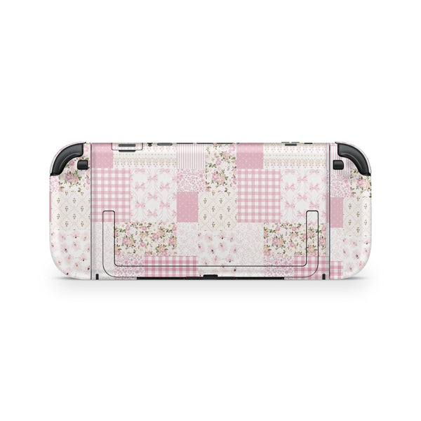 a Nintendo Switch console with a pink and white checkered pattern on its back cover.