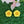 Charger l&#39;image dans la galerie, two yellow flower-shaped objects placed on a green surface, with a pink flower in the background.
