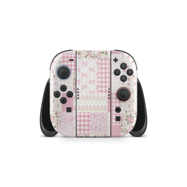 A Nintendo Wii game controller with a pink and white floral pattern design.