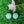 Charger l&#39;image dans la galerie, two green frog-shaped objects and a pink flower on a green grassy surface.
