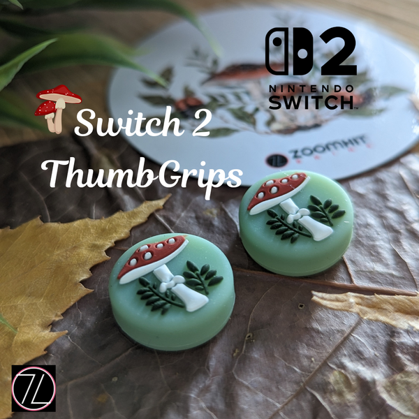 a pair of green thumb grips with mushroom and leaf designs, placed on a leaf and a white surface with a Nintendo Switch logo in the background.