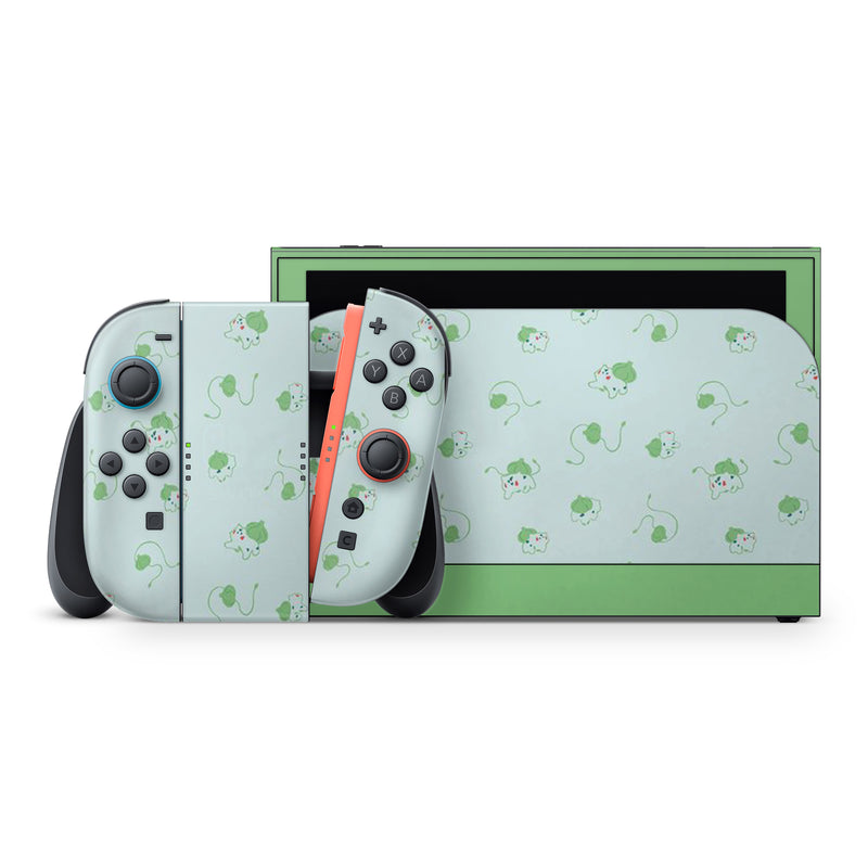 a Nintendo Wii console with a light green and black color scheme, adorned with a pattern of cartoon-like mice on its controllers and a matching green and black box.